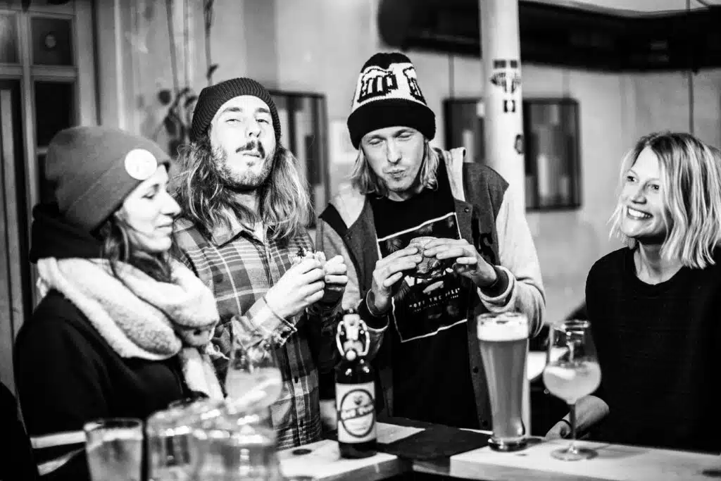 The image shows two boys and two girls having fun at Hostel Montagu Innsbruck